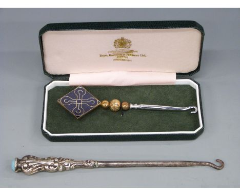 A cased hallmarked silver millennium button hook and a white metal handled button hook marked sterling with cabochon to top