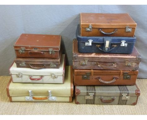 Nine various leather and other vintage suitcases, width of largest 64cm 
