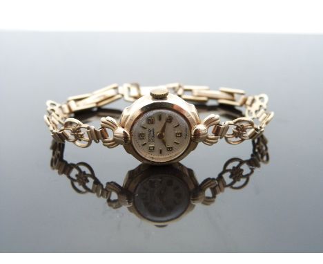 Rotary 9ct gold ladies wristwatch with gold hands, Arabic numerals, silver face and signed 15 jewel calibre 560 movement, on 