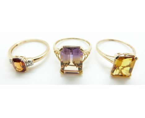 Three 9ct gold rings, one set with tourmaline, one citrine and the other citrine and diamonds, all size R/S, 7.49g  