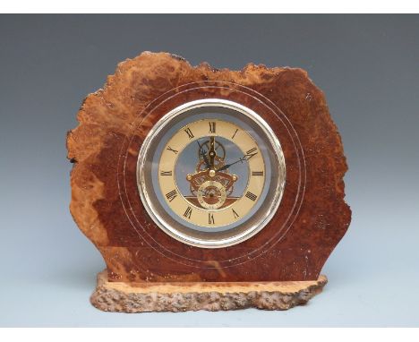 Rustic cased burr walnut mantel clock fitted with battery driven visible movement, the brass Roman dial with Arabic secondary