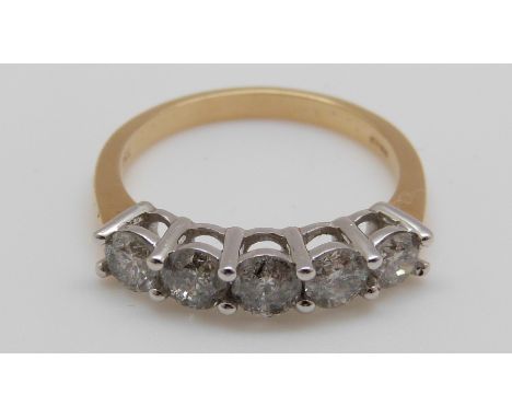 An 18ct gold ring set with five diamonds, the centre diamond approximately 0.28ct (size Q)