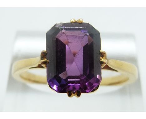 A yellow metal ring set with an emerald cut synthetic purple sapphire, size R/S, 4.4g 