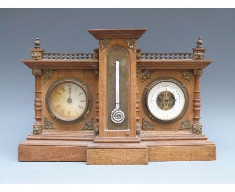 A German made Edwardian beechwood cased clock, barometer and thermometer compendium, decorated with brass spandrels and galle