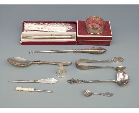 A hallmarked silver spoon, silver sugar tongs, silver ladle, silver napkin ring and boxed Yard-O-Led hallmarked silver pencil