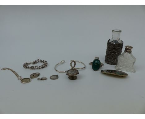 A silver Mexico brooch, Victorian silver button, two silver bangles, silver sleeve for a bottle, silver topped bottle and sil