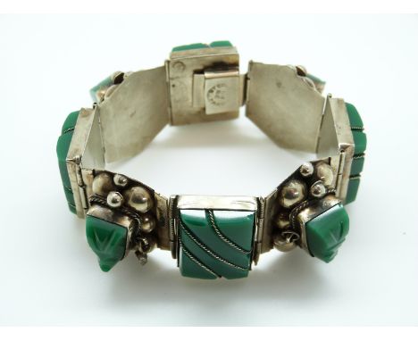 A Mexican sterling silver bracelet c1965 set with green onyx Mayan masks
