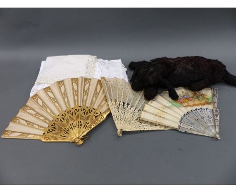 Three fans including mother-of-pearl and gilded together with a small quantity of textiles and a vintage straw-filled dog