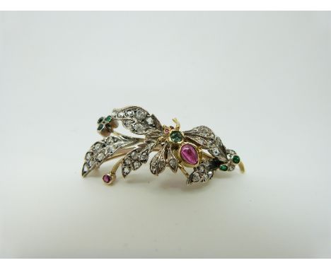 A Victorian brooch set with old cut and rose cut diamonds, a ruby cabochon and emeralds, depicting an insect amongst leaves, 