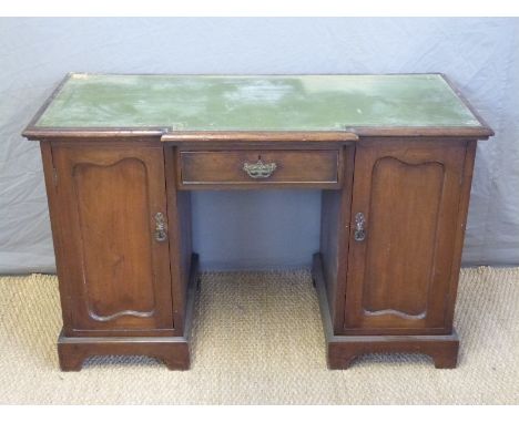 A twin pedestal leather inset break front desk, W124 x D56 x H78cm 