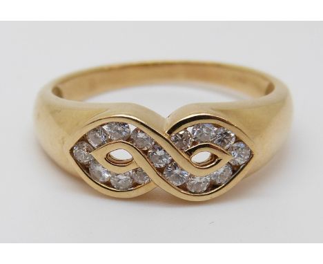 An 18ct gold ring set with diamonds in a twist, 3.56g (size N) 