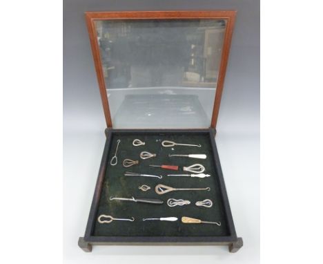 A display of 16 various button hooks including ivory handled, folding and other examples