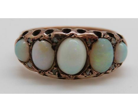 A 9ct gold ring set with five graduated opal cabochons and diamonds, Birmingham 1916, size P, 3g 