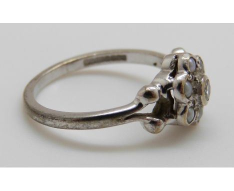 A 9ct white gold ring set with a diamond and seed pearls, 2.6g, size J/K 