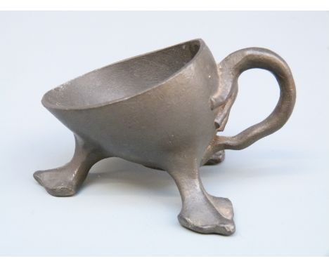 A pewter pipe rest numbered 21728