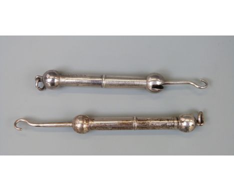 Two dumbell shaped hallmarked silver retractable button hooks