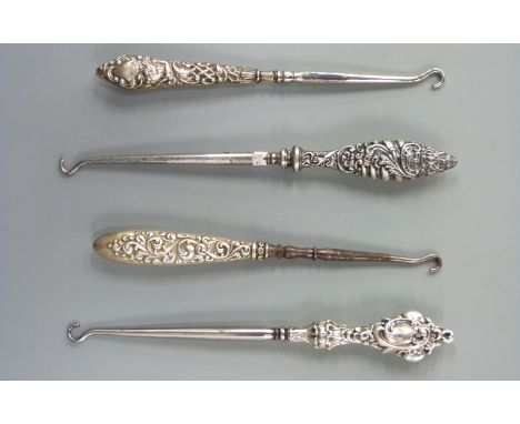 Four various hallmarked silver handled button hooks