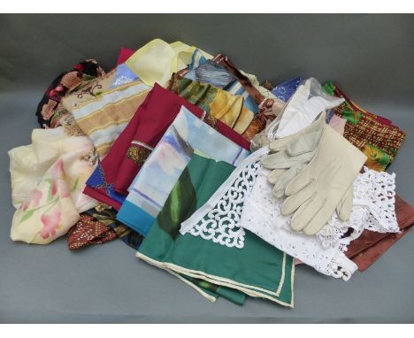 A collection of ladies scarves including silk examples together with other textiles including gloves and lace collars