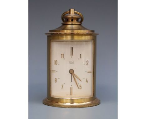 Solo c1950s alarm clock in brass cylindrical lantern style case, the ivory coloured dial with brass baton numerals, maker's n