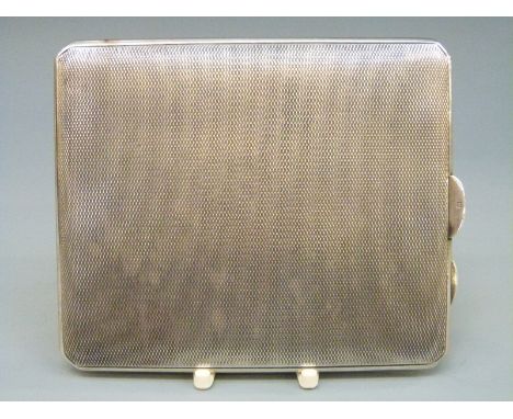 A George V hallmarked silver engine turned cigarette case, Birmingham 1934, width 10cm