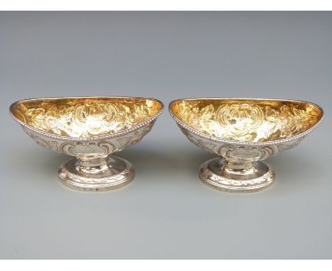 A pair of Georgian hallmarked silver open pedestal salts with embossed decoration and gilt interiors, London 1825, no visible