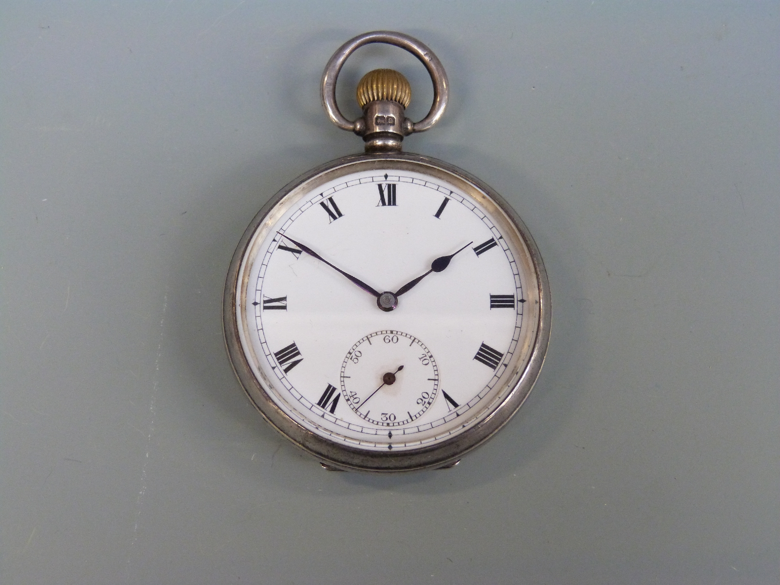 A hallmarked silver pocket watch, Birmingham 1928, and four lighters