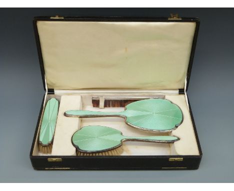 A Selfridge & Co Ltd George VI hallmarked silver and guilloché enamel dressing table set comprising hand mirror and two brush
