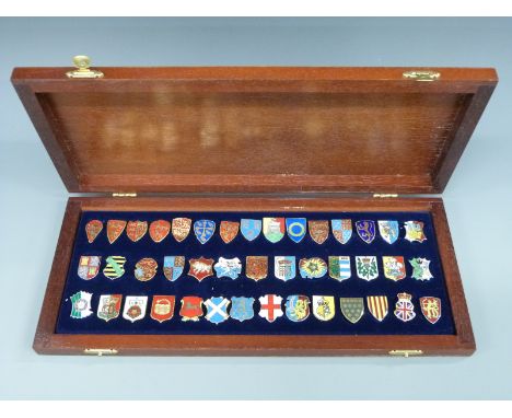 A cased set of 42 hallmarked silver and enamel Danbury Mint Heraldic Emblems of the Kings and Queens of England, with certifi