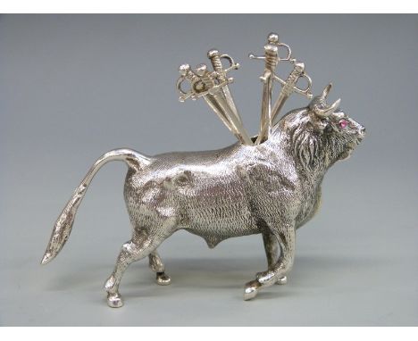 A continental white metal novelty cocktail stick holder in the form of a bull, length 10cm, weight 102g