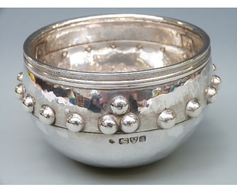 An Edward VII hallmarked silver model of the Glastonbury iron age bowl, of hammered and riveted Arts & Crafts style design, C