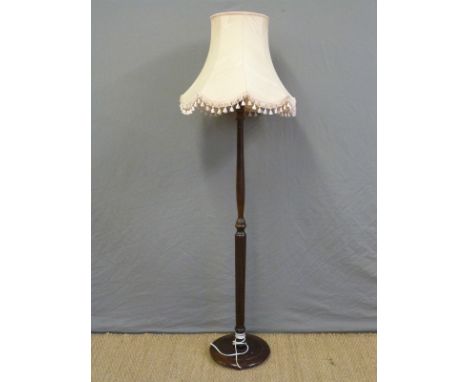 A wooden standard lamp