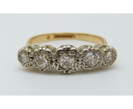 An 18ct gold ring set with five diamonds in an illusion setting, the centre stone approximately 0.25ct (size Q) 