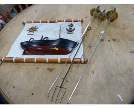 Wall hanging of a ship, three ornamental swords and a toasting fork. 