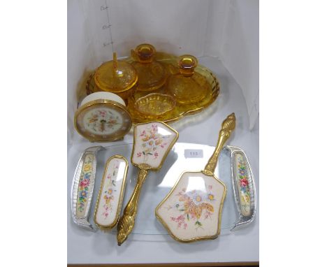 Amber-coloured five-piece glass dressing table set, three-piece brush set, similar tray and a similar mantel clock.