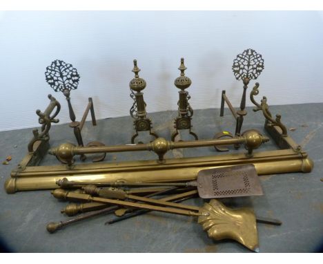 Brass fender, fire irons and dogs and a collection of brass fireside tools. 