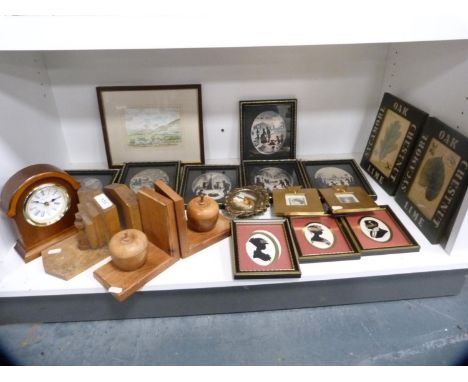 Regency-style portrait silhouettes, pair of Art Deco-style wooden bookends, modern mantel clock, pictures etc (one shelf). 