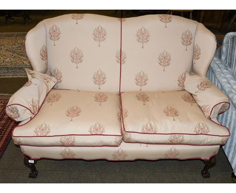 A wing back two seater sofa on ball and claw feet, 163cm wide 