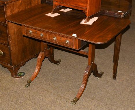 A 20th century small mahogany sofa table with two deep leaves, standing on curved legs and brass castors, 105cm by 61cm open 