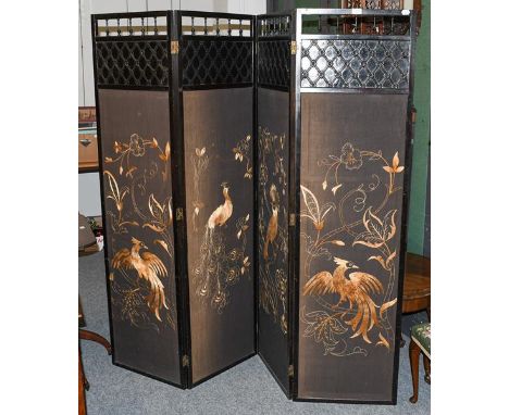 An Aesthetic movement ebonised four panel dressing screen, with gold embroidered panels depicting birds, each panel 48cm by 1