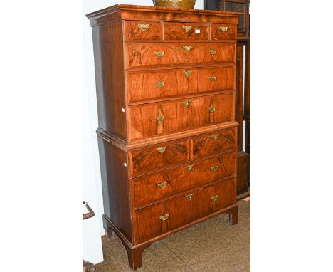 An 18th century walnut chest on chest, crossbanded and oak lined, with brass handles, raised on bracket supports, 103cm by 52