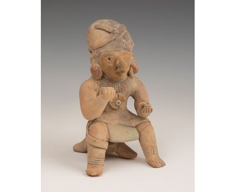 Pre-Columbian seated warrior; Jama Coaque Culture; Ecuador, 500 BC - 500 AD.Polychrome terracotta.Measurements: 19 x 10 x 10,