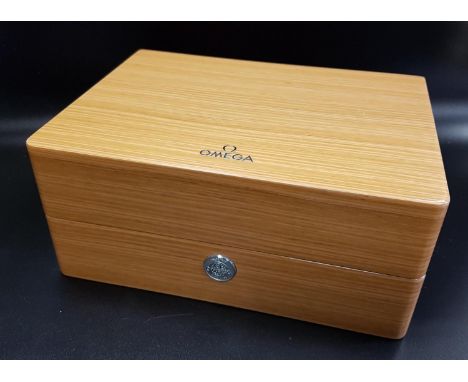 OMEGA WATCH BOXof faux wood design with push button opening mechanism, the fitted cream leather interior with red edge detail