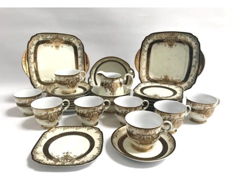 MEITO CHINA HAND PAINTED TEA SETthe cream ground with black band and gilt decoration, comprising eight cups, saucers and side