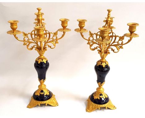 PAIR OF GILT METAL AND ENAMEL CANDELABRAeach with four shaped arms with shaped drip pans and holders with a central finial ab