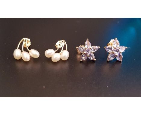 TWO PAIRS OF TEN CARAT GOLD MOUNTED STUD EARRINGScomprising one pair set with three small pearls to each and the other light 