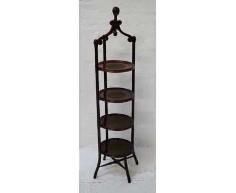 EDWARDIAN MAHOGANY CAKE STANDthe four circular tiers with inset linen sections, with three shaped supports and finial, standi