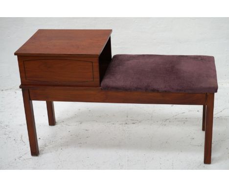 TEAK TELEPHONE TABLEthe raised square top with a shelf below and padded seat, standing on plain supports, 89cm long 