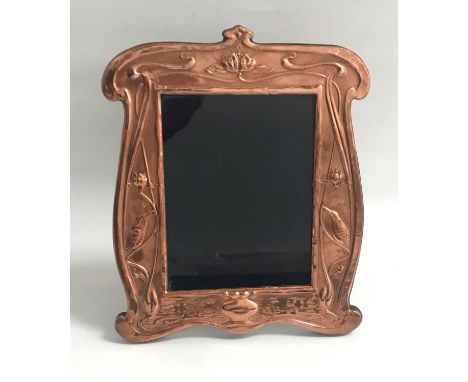 ART NOUVEAU STYLE COPPER PHOTOGRAPH FRAMEthe shaped frame with relief bird and scroll decoration, on easel support, 32cm high