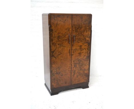 WALNUT WARDROBEof small proportions, with a moulded top above two doors opening to reveal a hanging space, shoe rack and five