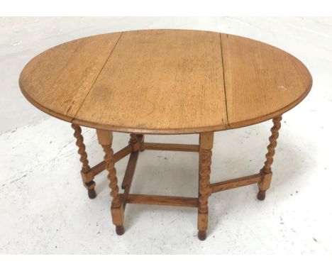 LIGHT OAK GATELEG DINING TABLEwith shaped drop flaps, standing on barley twist supports united by stretchers, 91cm wide 